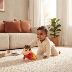 A South Asian baby crawling on a cream rug in a sunlit living room while playing with a Shinchan developmental toy.